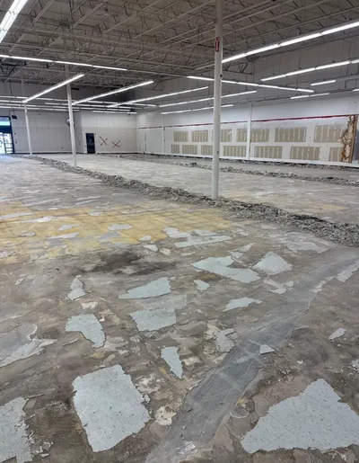 Retail slab part cleared, with windrows of broken tile waiting to be removed