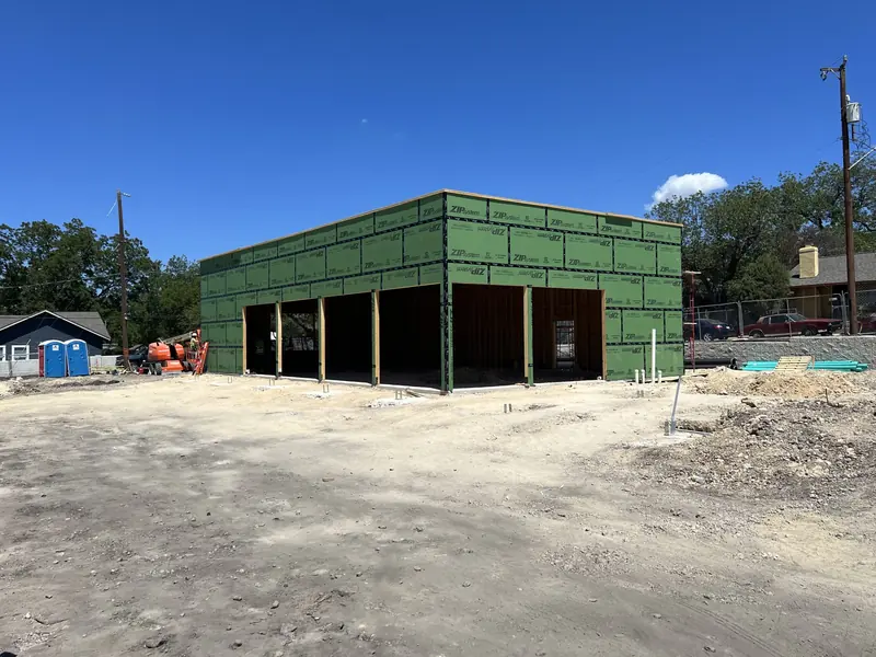 Commercial building sheathed and framed with the storefront openings cut in