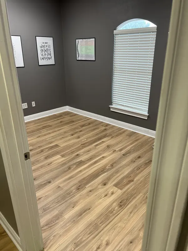 Light oak luxury vinyl plank flooring installed through a hallway