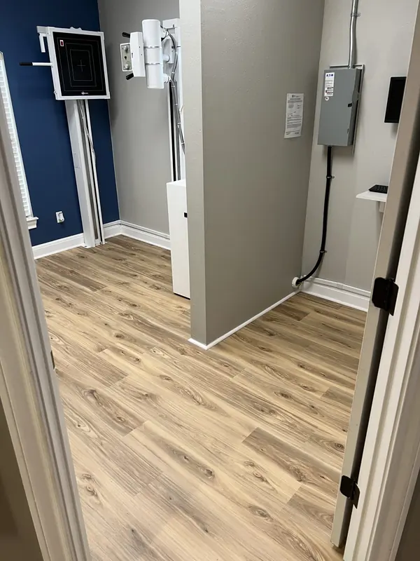Wood look plank flooring running between two bedrooms