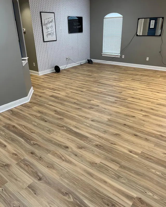 Warm toned vinyl plank flooring in a newly painted room
