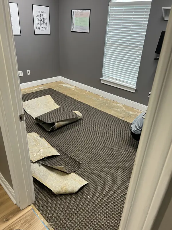 Carpet tile being laid out during a commercial flooring install