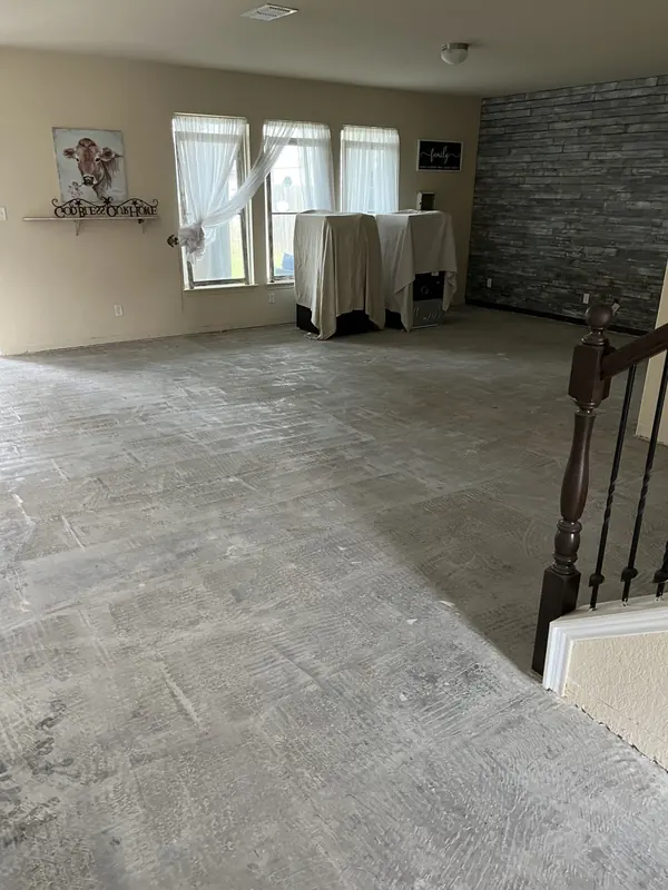 Large format tile flooring in an open living and dining area