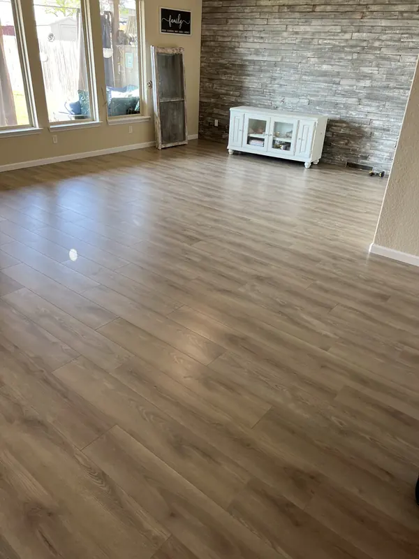 Wide plank flooring installed through an open plan living space