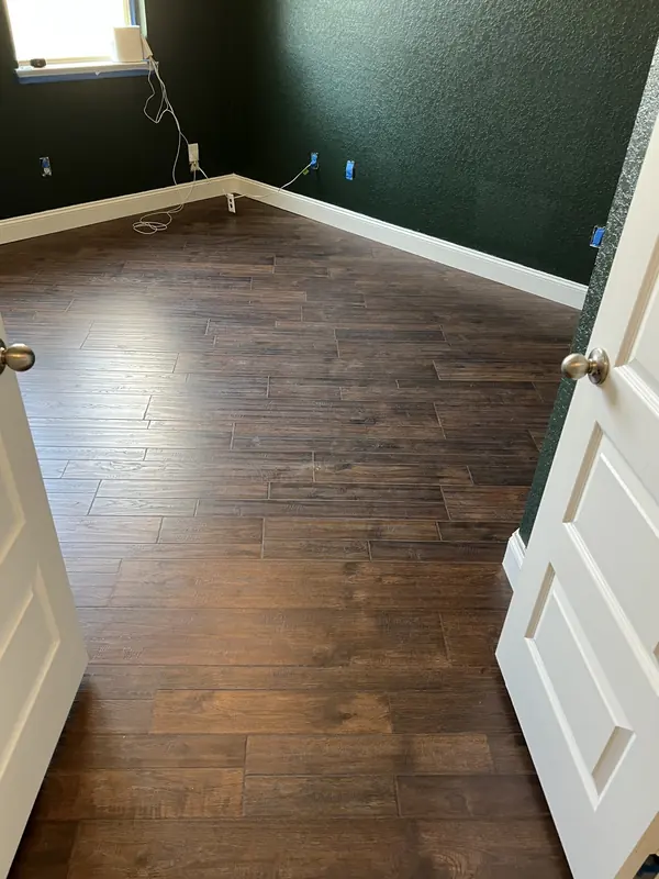 Hardwood flooring installed in a hallway between two rooms