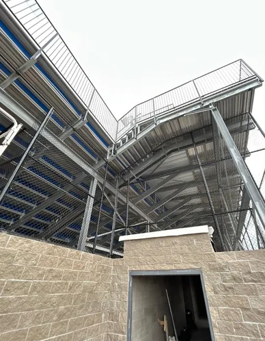Chain link safety fencing fitted to the steel underside of a grandstand