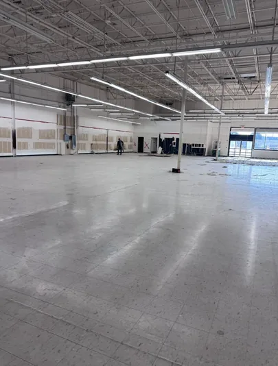 Retail unit with the floor stripped back and the space swept through
